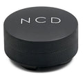 CMI NCD coffee distributor with a textured handle and stainless steel head for even coffee grounds distribution.